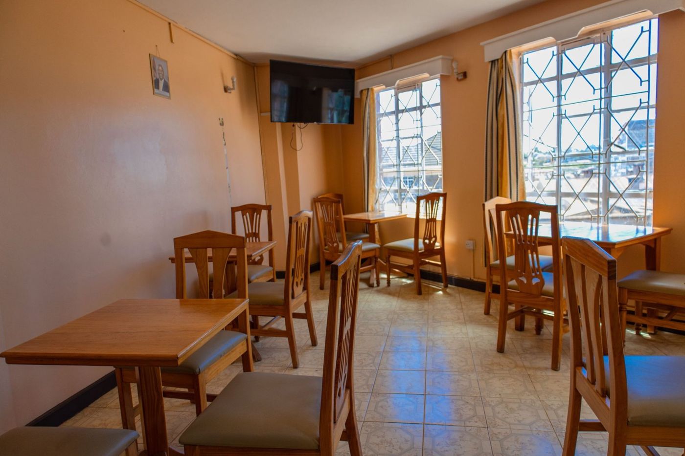 Dining hall with wooden tables by large windows